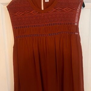Burnt orange sleeveless top with detailed neckline